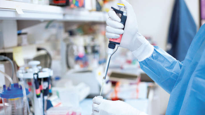 science lab, pipetting, protection suit and gloves